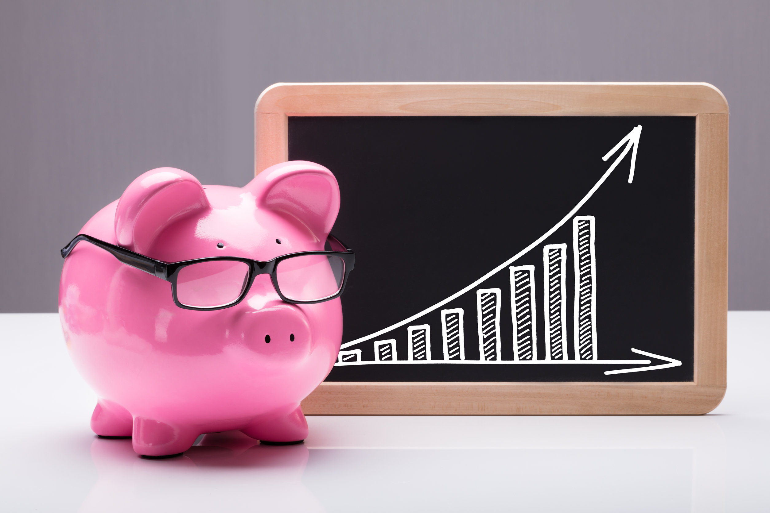Pink Pig Piggy Bank Near Chart With Arrow Showing Progress And Growth On Slate